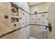 Shower featuring decorative, detailed tile work and design with built in shelf at 1622 El Tair Trl, Clearwater, FL 33765