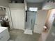 This bathroom features a glass-enclosed shower, white tile, neutral walls, and access to the adjacent bedroom at 18108 Ashton Park Way, Tampa, FL 33647