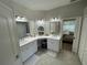 This spacious bathroom features dual sinks with white cabinetry, modern lighting, and an open doorway to the bedroom at 18108 Ashton Park Way, Tampa, FL 33647