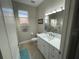 Cozy bathroom featuring a shower-tub combo with a patterned curtain, neutral walls, and a modern vanity at 18108 Ashton Park Way, Tampa, FL 33647