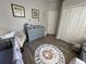 Bedroom with an alphabet rug, gray dresser, elephant decor, and neutral walls at 18108 Ashton Park Way, Tampa, FL 33647