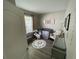 This Bedroom features a grey crib, alphabet rug, comfortable rocking chair, and soft neutral décor at 18108 Ashton Park Way, Tampa, FL 33647