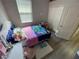 A well lit bedroom with a bed and toys, a closet and a small keyboard at 18108 Ashton Park Way, Tampa, FL 33647