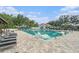 Large community pool featuring lounge chairs, a slide, and a building with a covered area at 18108 Ashton Park Way, Tampa, FL 33647