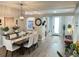 Elegant dining room features stylish lighting and views of the kitchen and front entryway at 18108 Ashton Park Way, Tampa, FL 33647