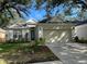 Charming single-story home featuring a well-manicured lawn and a two-car garage at 18108 Ashton Park Way, Tampa, FL 33647