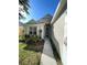 Front exterior with manicured lawn and lush landscaping and a lovely walkway to the door at 18108 Ashton Park Way, Tampa, FL 33647
