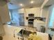 Modern kitchen with white cabinets, stainless steel appliances, and quartz countertops at 18108 Ashton Park Way, Tampa, FL 33647