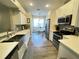 Bright kitchen with stainless steel appliances and quartz countertops and a view to the dining area at 18108 Ashton Park Way, Tampa, FL 33647