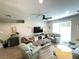 Cozy living room features a ceiling fan, modern fireplace, and sliding glass doors at 18108 Ashton Park Way, Tampa, FL 33647