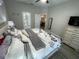 Well-lit bedroom with a neutral color scheme, a ceiling fan, and views into the home at 18108 Ashton Park Way, Tampa, FL 33647