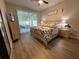 Comfortable bedroom featuring a ceiling fan, a king-size bed, and sliding glass doors to the patio at 18108 Ashton Park Way, Tampa, FL 33647