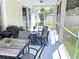 Relaxing screened patio features outdoor furniture, providing a comfortable space to enjoy the outdoors at 18108 Ashton Park Way, Tampa, FL 33647