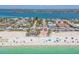 Aerial view of a beachfront area with a park, parking, and a sandy shoreline at 200 1St Ave # 406, St Pete Beach, FL 33706
