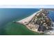 Scenic aerial view featuring sandy beach and the building, offering waterfront living at 200 1St Ave # 406, St Pete Beach, FL 33706