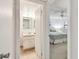 Bathroom view showcasing a vanity and tile flooring, conveniently located near a bedroom at 200 1St Ave # 406, St Pete Beach, FL 33706