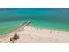 A wide shot of the beach and pier with a turquoise ocean background at 200 1St Ave # 406, St Pete Beach, FL 33706