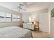 Bright bedroom features shuttered windows, neutral decor, and a built-in dresser at 200 1St Ave # 406, St Pete Beach, FL 33706