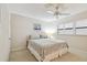 Comfortable bedroom with light, ceiling fan, shuttered windows, and decor at 200 1St Ave # 406, St Pete Beach, FL 33706