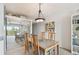 Stylish dining space with unique light fixture and seating for four, adjacent to a mirrored wall at 200 1St Ave # 406, St Pete Beach, FL 33706