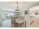 Dining area with seating for four, leading to a light and airy living space at 200 1St Ave # 406, St Pete Beach, FL 33706