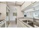 Kitchen view with pass-through to living area and stainless steel appliances at 200 1St Ave # 406, St Pete Beach, FL 33706
