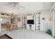 Open-concept living room and dining area with built-in shelving and balcony access at 200 1St Ave # 406, St Pete Beach, FL 33706