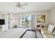 Inviting living room featuring a ceiling fan, access to a balcony, and natural light at 200 1St Ave # 406, St Pete Beach, FL 33706