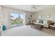 Bright living room featuring a comfortable sofa, ceiling fan, and sliding glass doors to the balcony at 200 1St Ave # 406, St Pete Beach, FL 33706