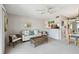 Comfortable living room with neutral colors, ceiling fan, and access to dining room and kitchen at 200 1St Ave # 406, St Pete Beach, FL 33706