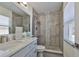 Updated bathroom with a decorative tiled shower, modern vanity, and ample natural light at 2011 S Carolina Ave, Tampa, FL 33629