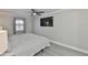 This is a bedroom that has a ceiling fan and TV on the wall at 2011 S Carolina Ave, Tampa, FL 33629