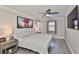 Bedroom with a ceiling fan, a window with curtains, gray walls, and light gray wood-look floors at 2011 S Carolina Ave, Tampa, FL 33629