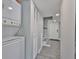 Bright entryway featuring a stacked washer/dryer, coat closet, and tiled flooring at 2011 S Carolina Ave, Tampa, FL 33629