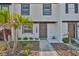 Charming townhouse entrance with decorative rock and mulch landscaping plus white painted brick facade at 2011 S Carolina Ave, Tampa, FL 33629