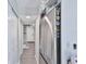 A sleek hallway with updated flooring and stainless-steel refrigerator, and extra storage space at 2011 S Carolina Ave, Tampa, FL 33629