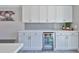 A modern kitchen has updated cabinets, countertops, a beverage refrigerator and stainless steel appliances at 2011 S Carolina Ave, Tampa, FL 33629