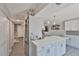 A modern kitchen features a spacious island with quartz countertop and tile flooring at 2011 S Carolina Ave, Tampa, FL 33629