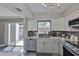Contemporary kitchen features stainless steel appliances and sliding glass door to the patio at 2011 S Carolina Ave, Tampa, FL 33629