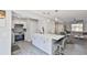 A kitchen featuring an open layout with white cabinets, quartz countertops, and stainless-steel appliances at 2011 S Carolina Ave, Tampa, FL 33629