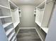 A spacious walk-in closet with white shelving and wood-style flooring offers ample storage at 2011 S Carolina Ave, Tampa, FL 33629