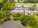 Community aerial view showcasing a pond and trees near the residences at 210 Cypress Ct # 122, Oldsmar, FL 34677