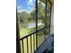 Relaxing screened balcony with a scenic view of the lake and lush landscaping at 210 Cypress Ct # 122, Oldsmar, FL 34677