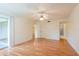 Large bedroom with hardwood floors, ceiling fan, closet, access to bathroom, and balcony at 210 Cypress Ct # 122, Oldsmar, FL 34677