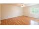 Spacious bedroom featuring wood-look floors, a ceiling fan, closet, and a window at 210 Cypress Ct # 122, Oldsmar, FL 34677