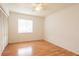 Bedroom featuring laminate floors, a ceiling fan, sliding closet doors, and a large window at 210 Cypress Ct # 122, Oldsmar, FL 34677