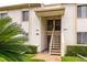 Well-maintained two-story building exterior with stair access and tropical landscaping at 210 Cypress Ct # 122, Oldsmar, FL 34677