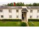 Charming two-story condominium exterior surrounded by manicured lawn and mature trees at 210 Cypress Ct # 122, Oldsmar, FL 34677