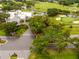 Aerial shot of a charming clubhouse entrance near a golf course, featuring lush landscaping and convenient parking at 210 Cypress Ct # 122, Oldsmar, FL 34677