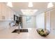 Bright kitchen with modern pendant lighting, quartz countertops, stainless steel appliances, and a ceiling fan at 210 Cypress Ct # 122, Oldsmar, FL 34677
